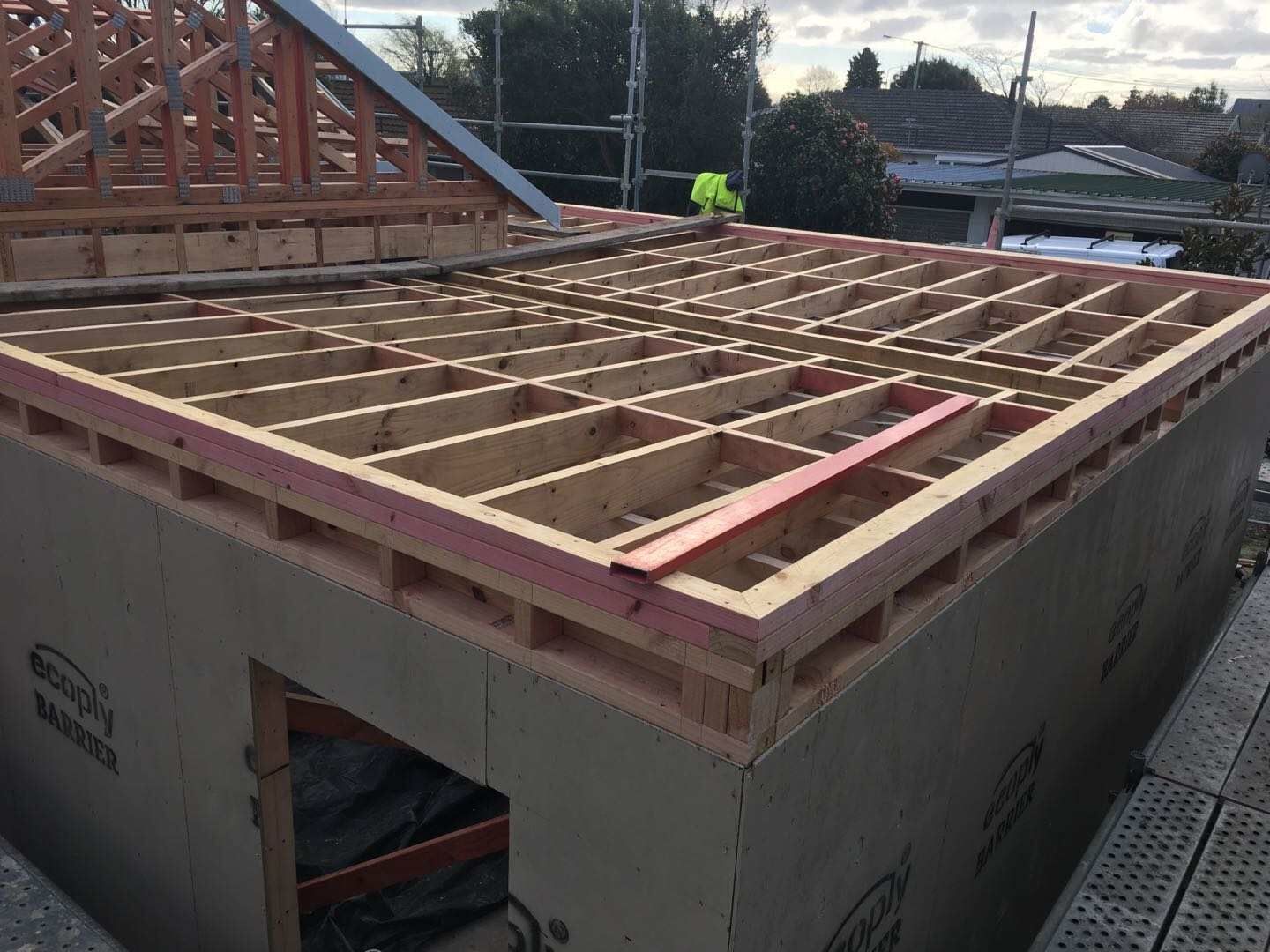 A wooden structure is being built on top of a building.
