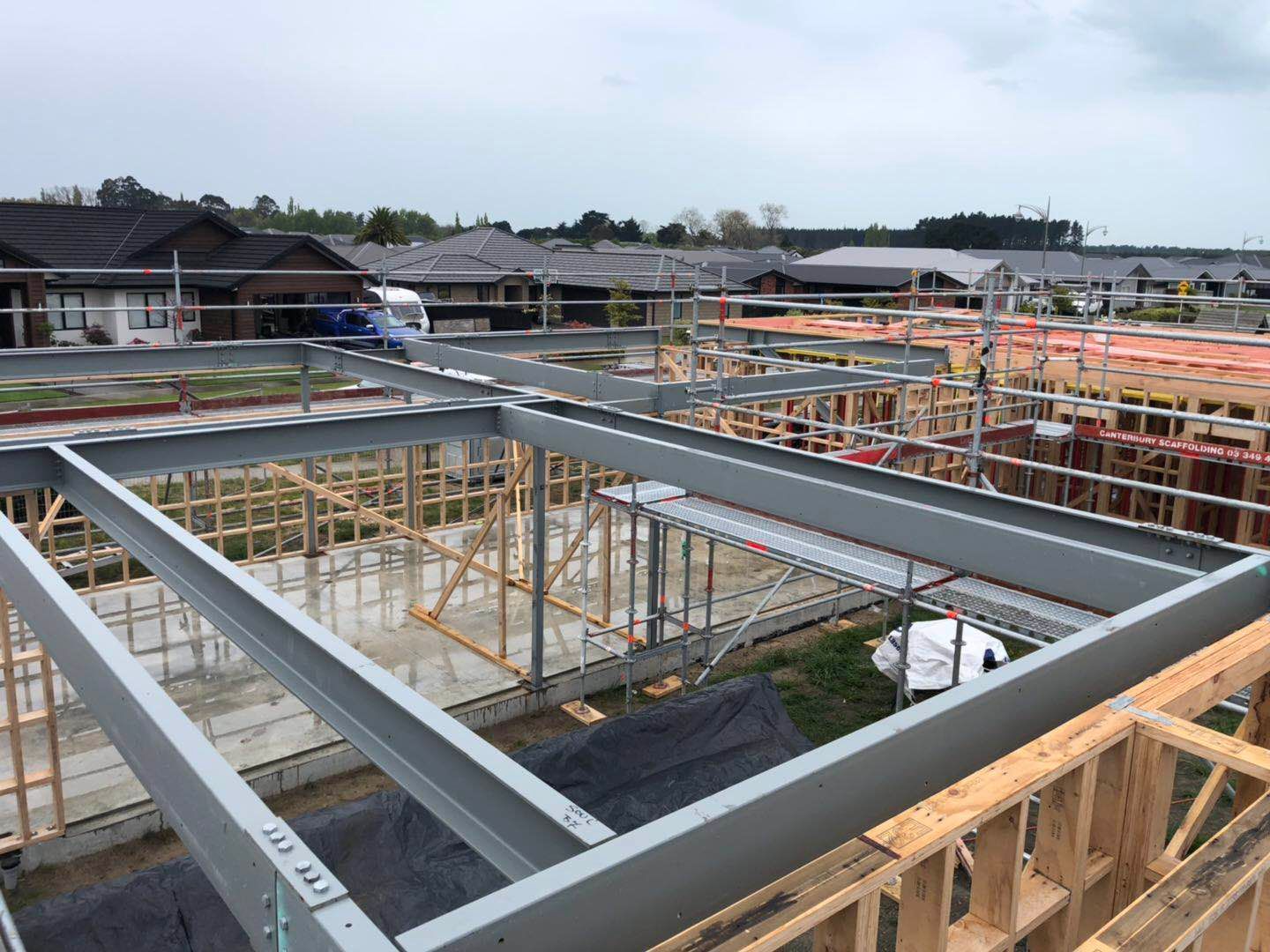 A large metal structure is being built on top of a wooden structure.