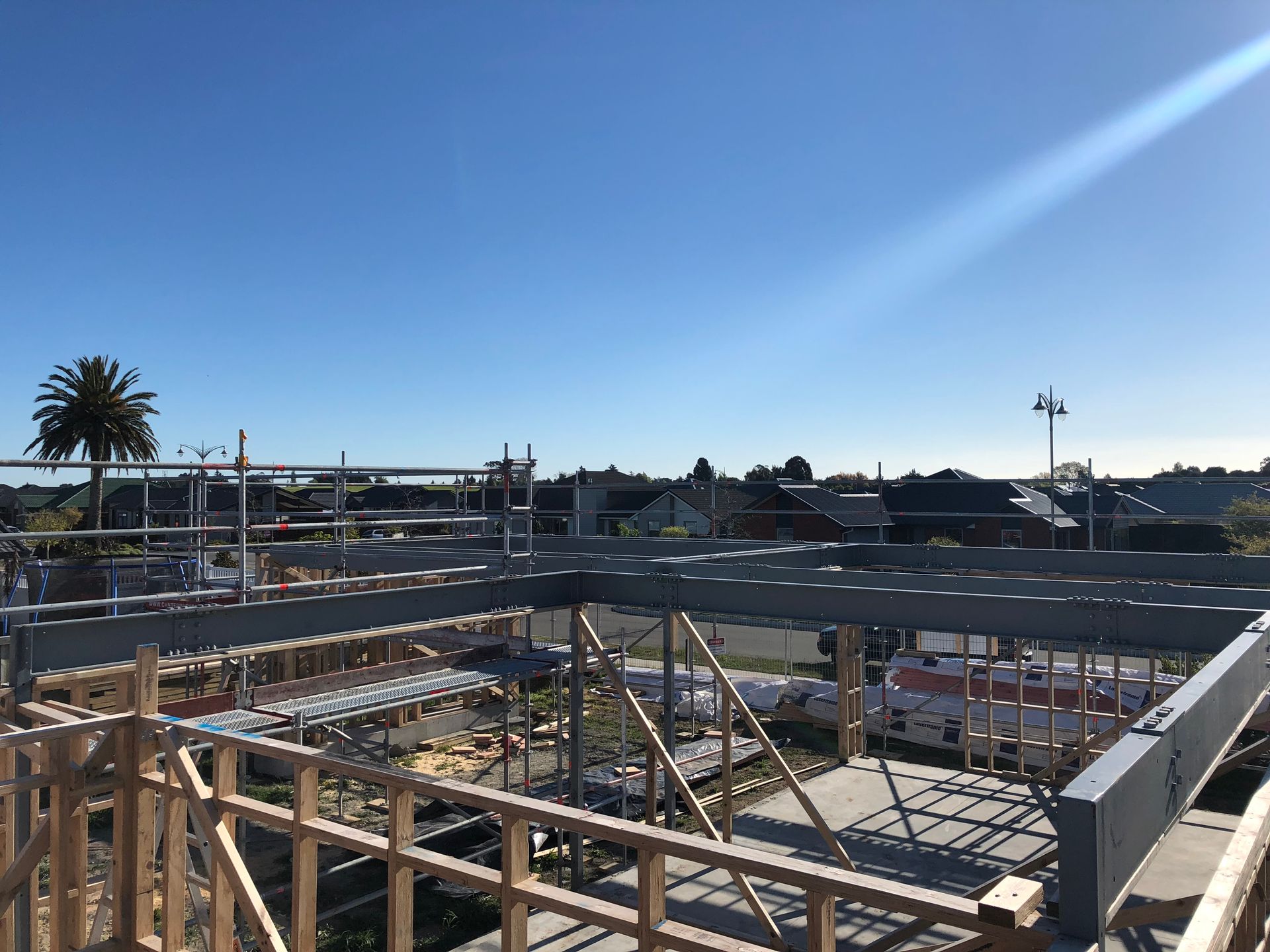 A building under construction with a blue sky in the background.