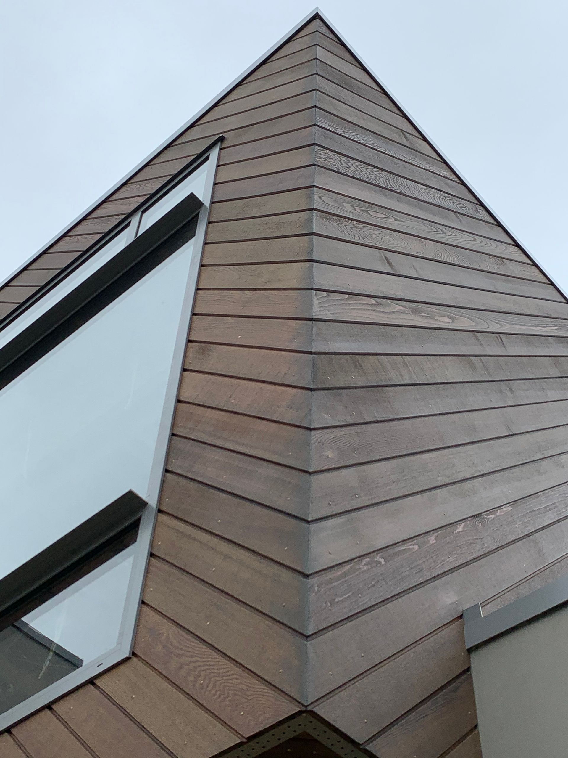 Looking up at the corner of a building with a large window