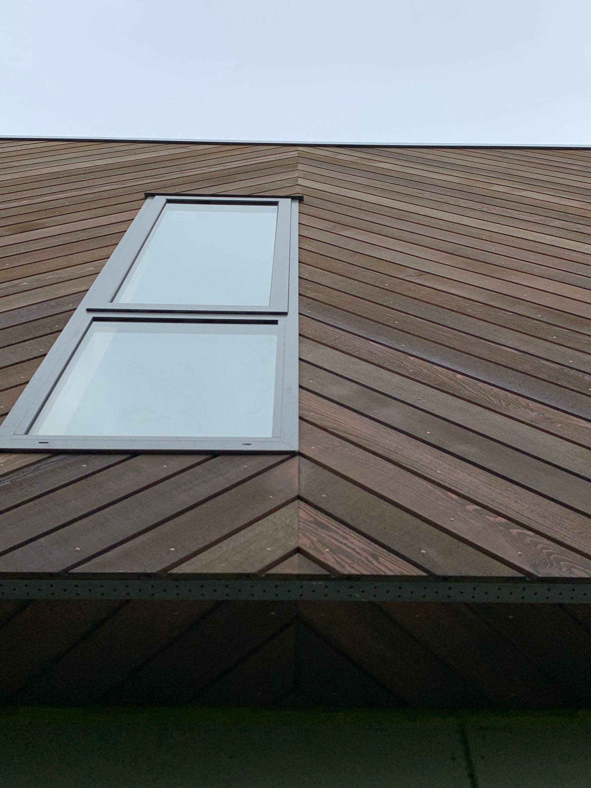 A wooden roof with a skylight on it