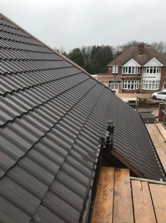 Picture of a new gable roof during replacement in grey concrete tile by Roofers Nottingham