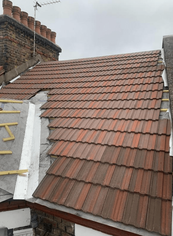 Picture of a new roof with dormer and lead valley being replaced in Red concrete tile by Roofers Nottingham