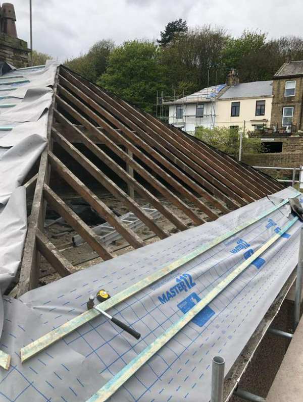 Picture of a roof undergoing a roof replacement by roofers Nottingham.
