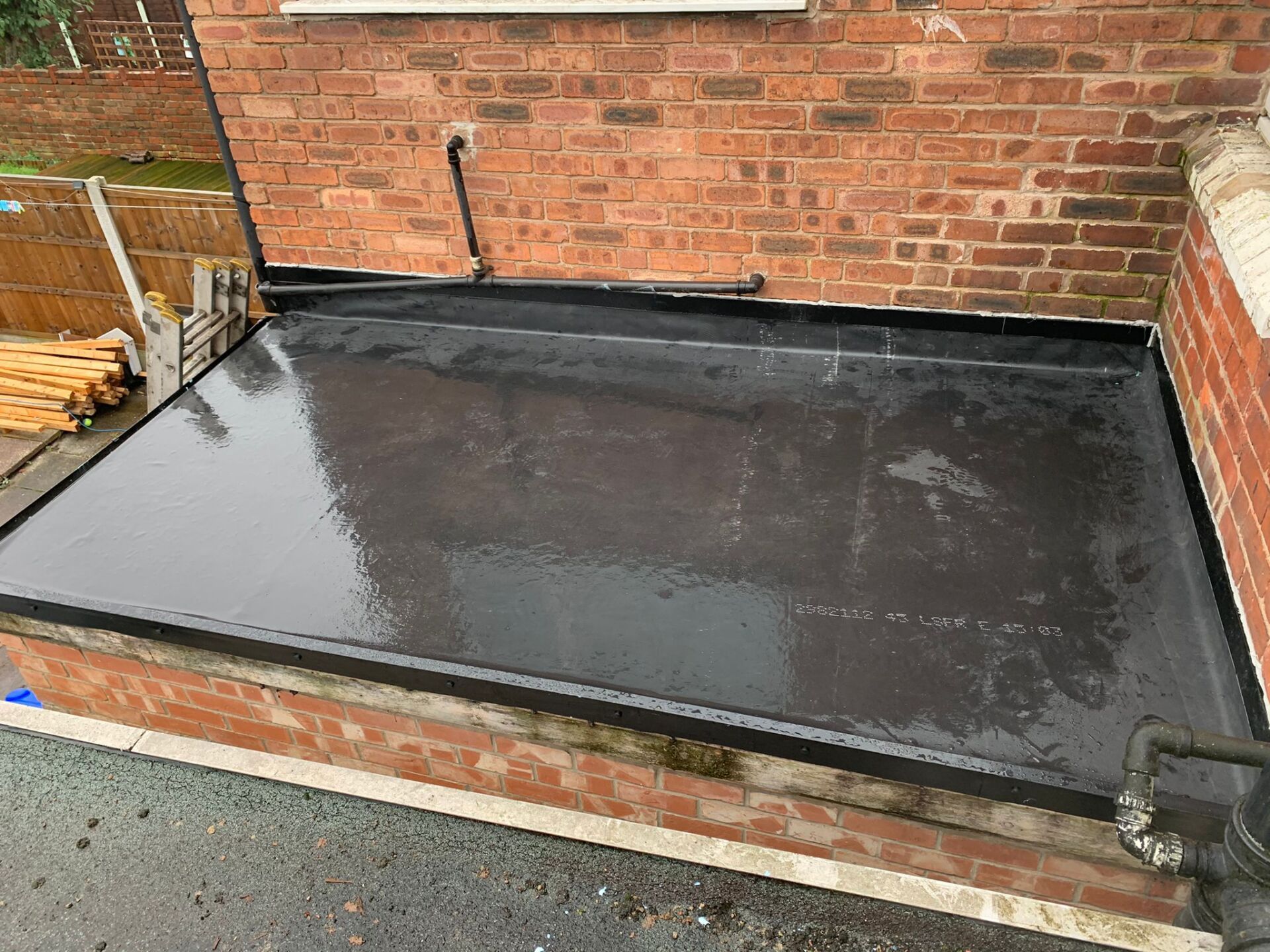 Picture of a flat outbuilding roof repaired and covered in liquid plastic by Roofers Nottingham