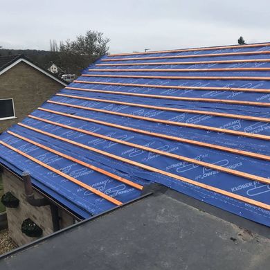 A picture of  a membrane and new wooden batons being laid on a pitched roof by Roofers Nottingham