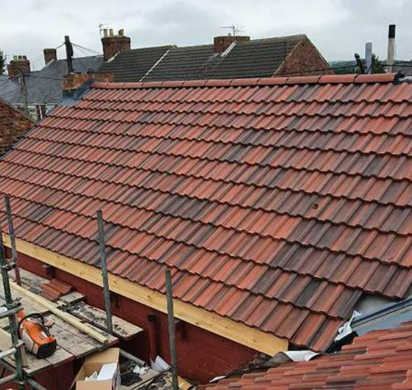 Picture of a new red concrete tile roof replacement carried out by Roofers Nottingham