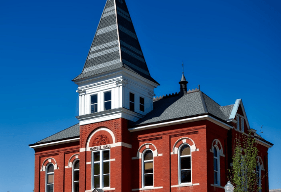 A large red brick building with a steeple on top