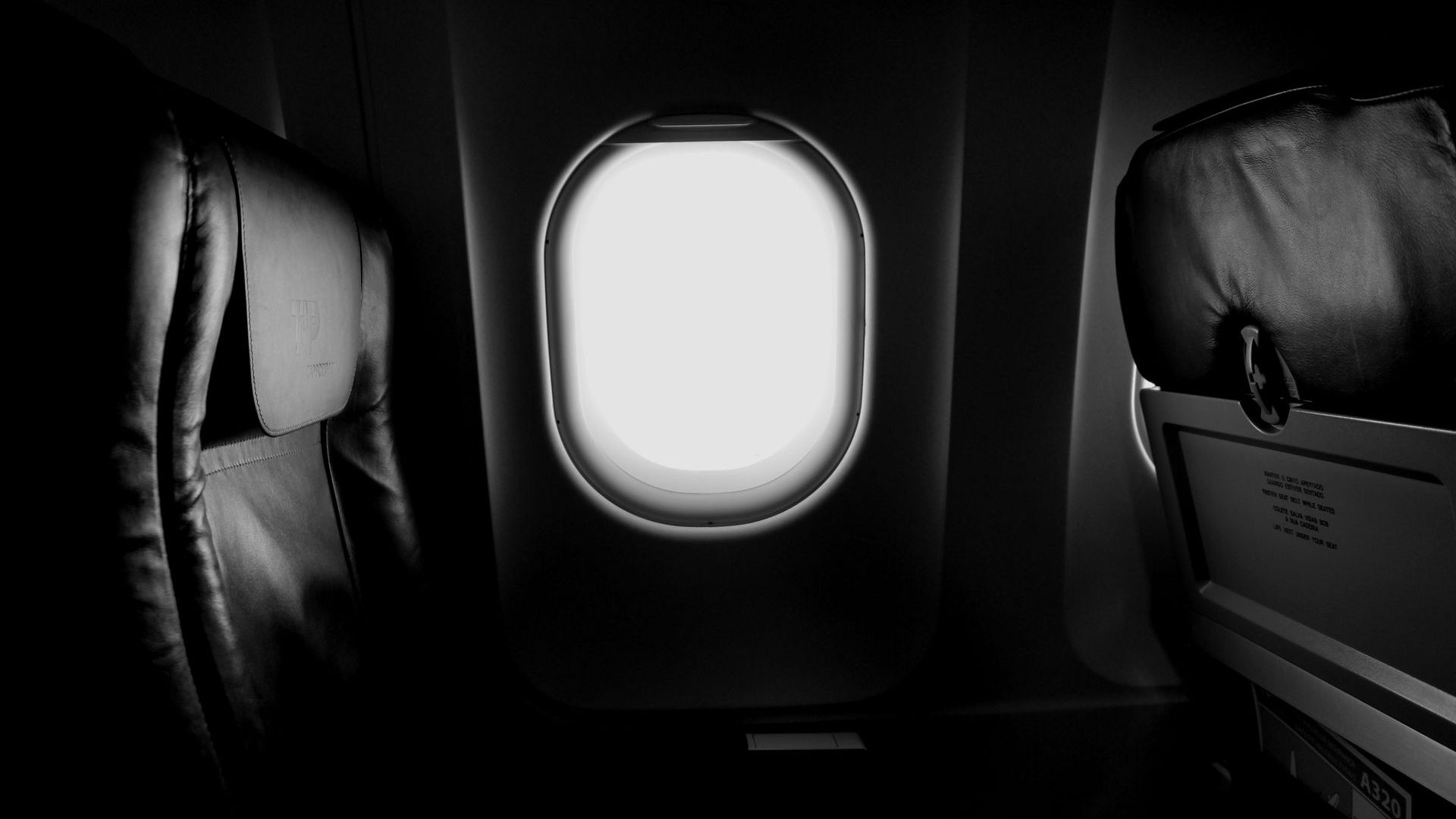 A black and white photo of an airplane with a window