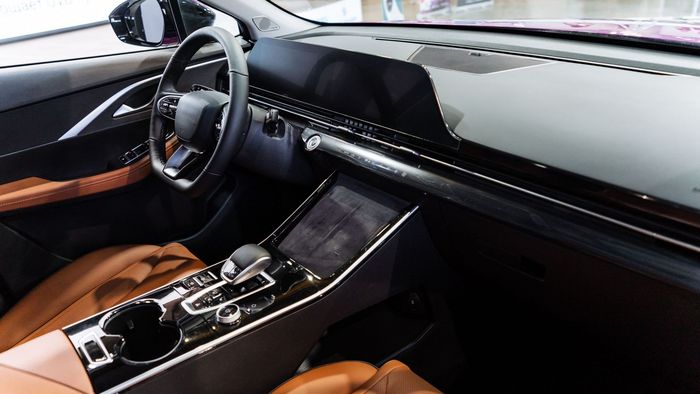 The interior of a car with a steering wheel and a dashboard.