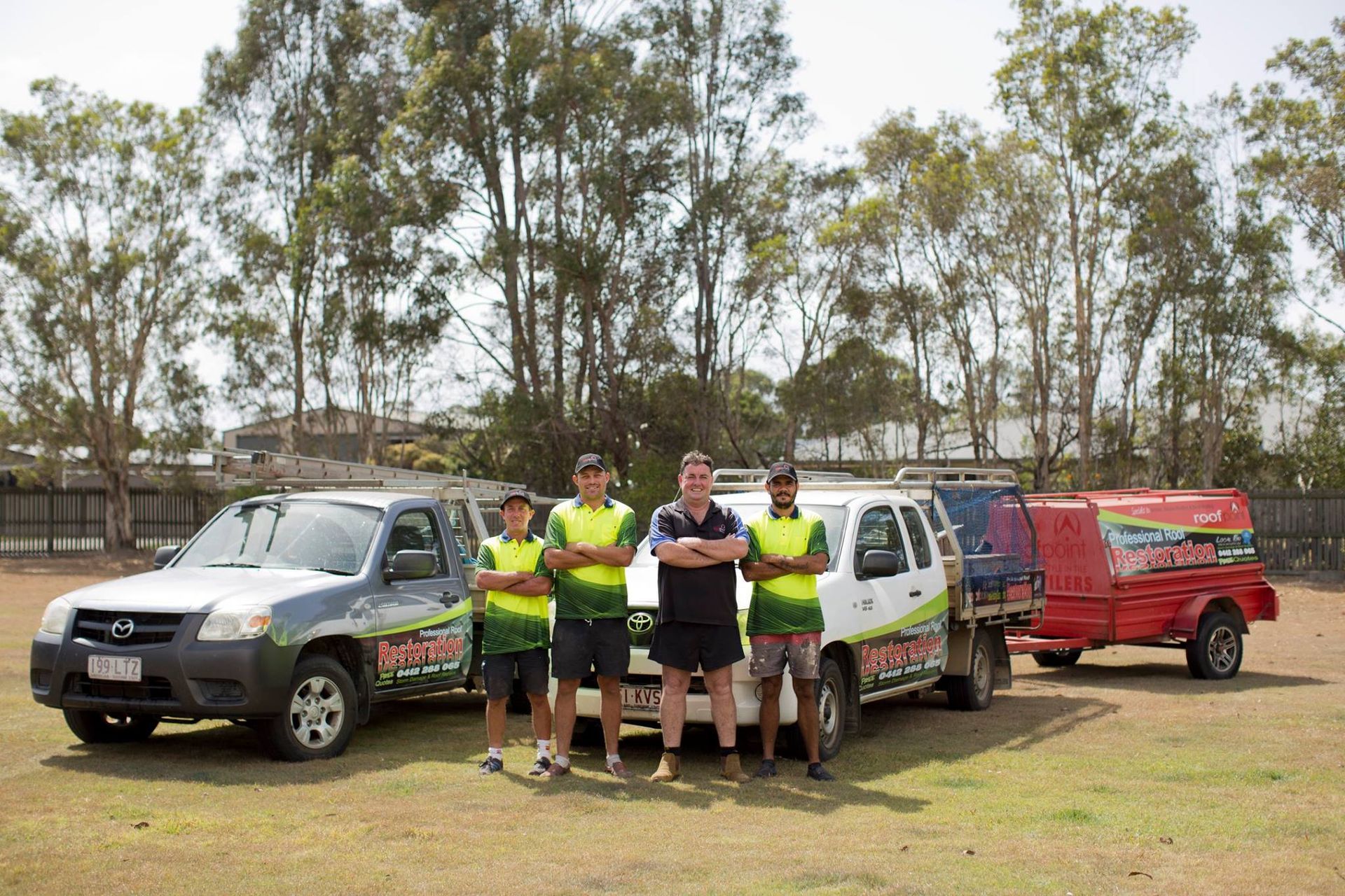 A Man is Writing on a Piece of Paper Next to a Model House and Keys — Roofpoint In Kawungan, QLD