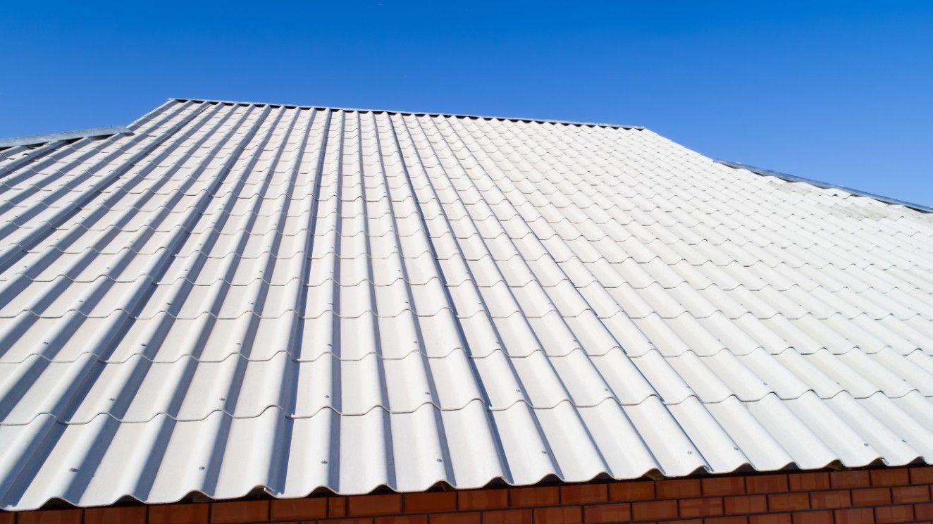 A White Roof With a Blue Sky in the Background — Roofpoint In Kawungan, QLD