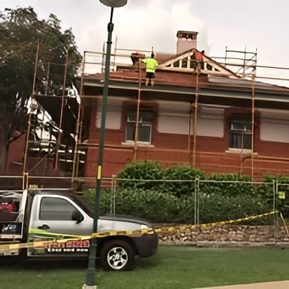 A Truck is Parked in Front of a Brick Building That is Under Construction — Roofpoint In Kawungan, QLD