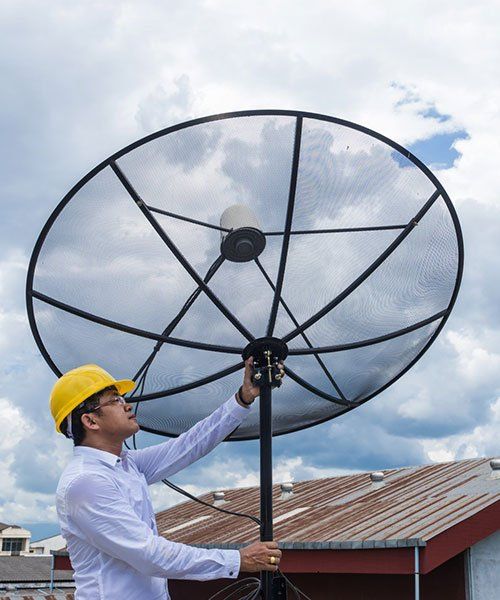 A Man Installing An Antenna — Coastwide Antennas in Wamberal NSW