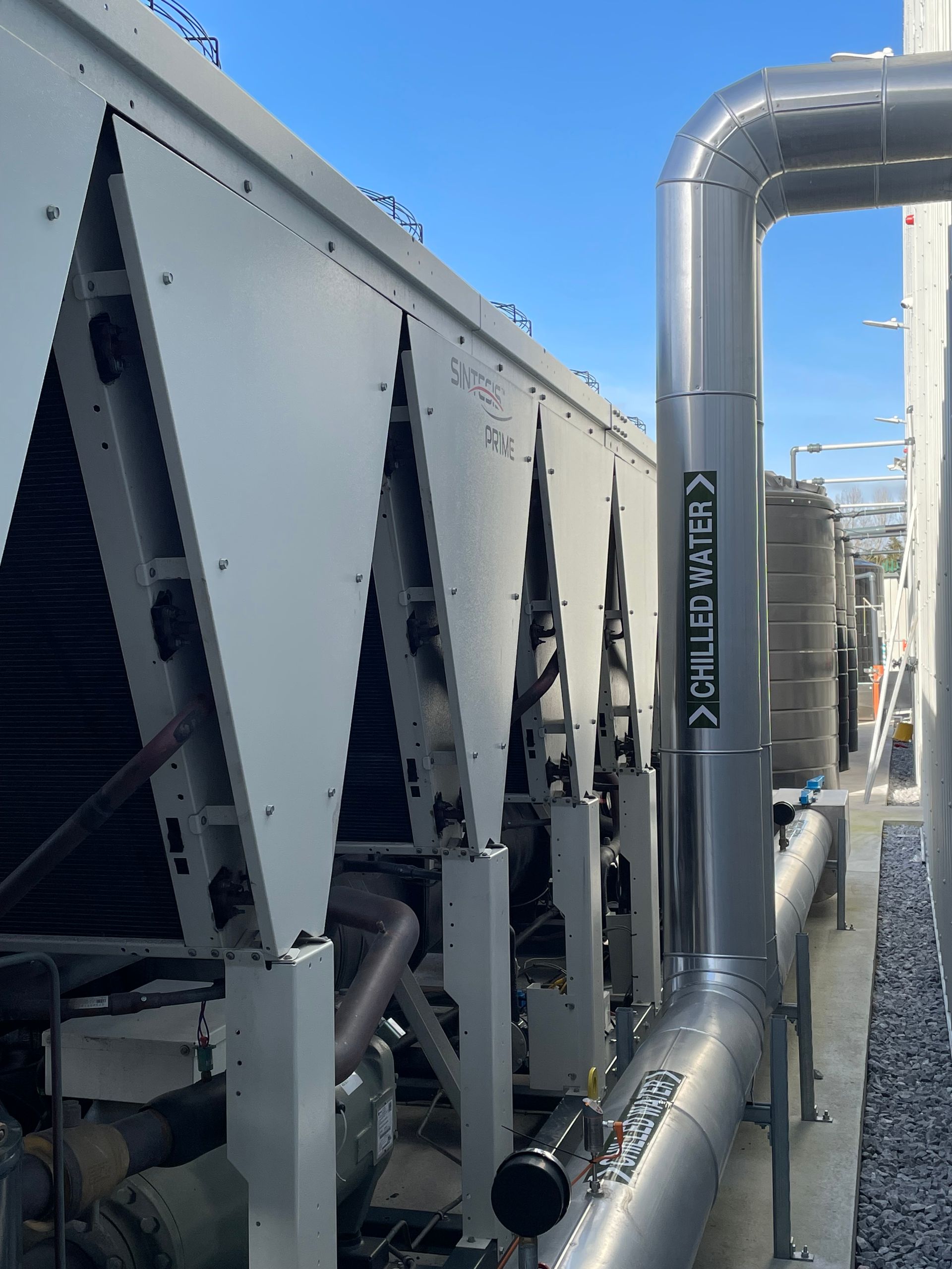 Industrial air conditioning unit with metal piping labeled