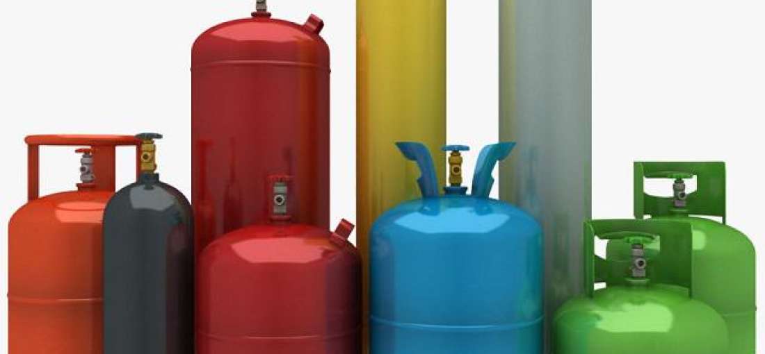 Colorful compressed gas cylinders in a variety of shapes and sizes, against a white backdrop.