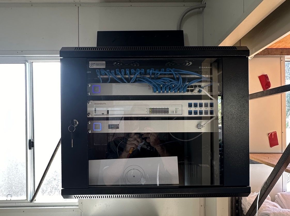 Black Network Server Rack on a Wall, Containing Networking Equipment — LSEA Electrical Group in Bucasia QLD