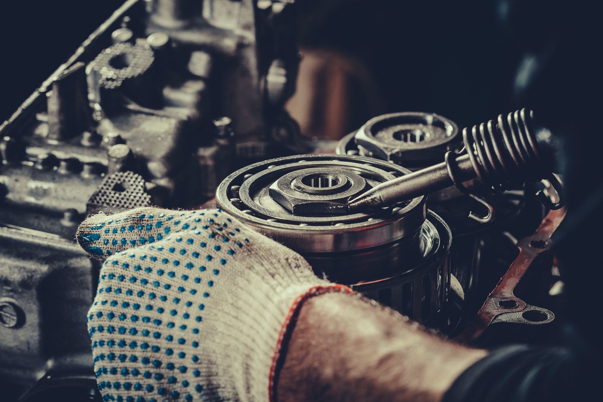 Mechanic repairing a transmission at AC Transmission Center, transmission shop in Denver, CO, ensuri