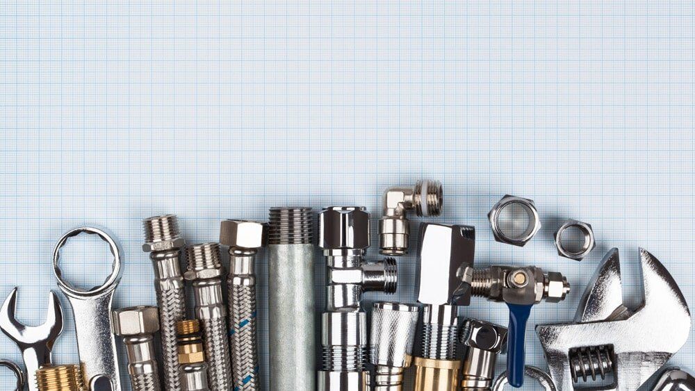 A bunch of plumbing tools are sitting on a table.