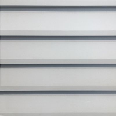 Horizontal rows of gray siding, casting shadows, creating a textured pattern.