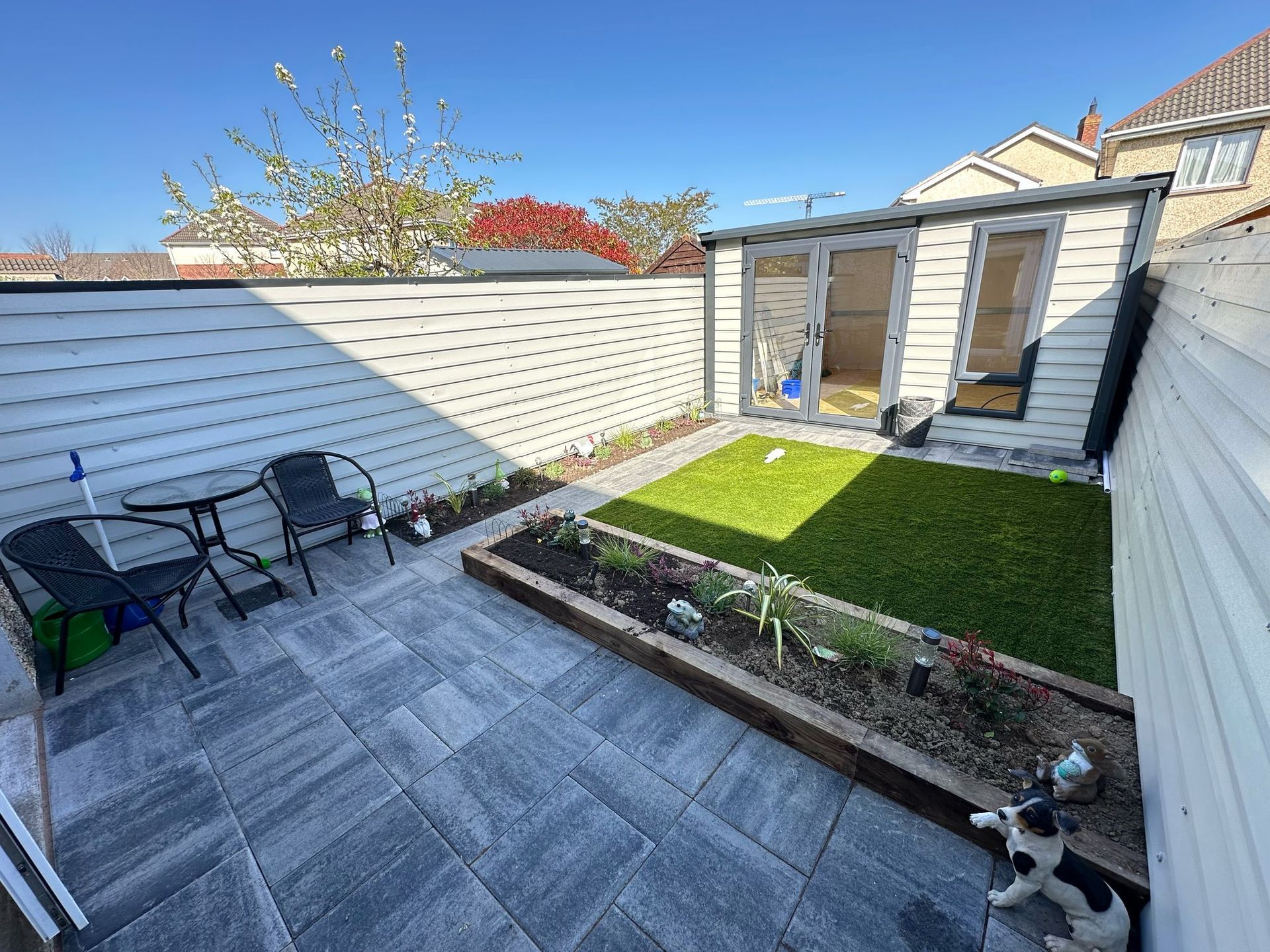 Dark gray wooden deck with a grassy lawn in the background.