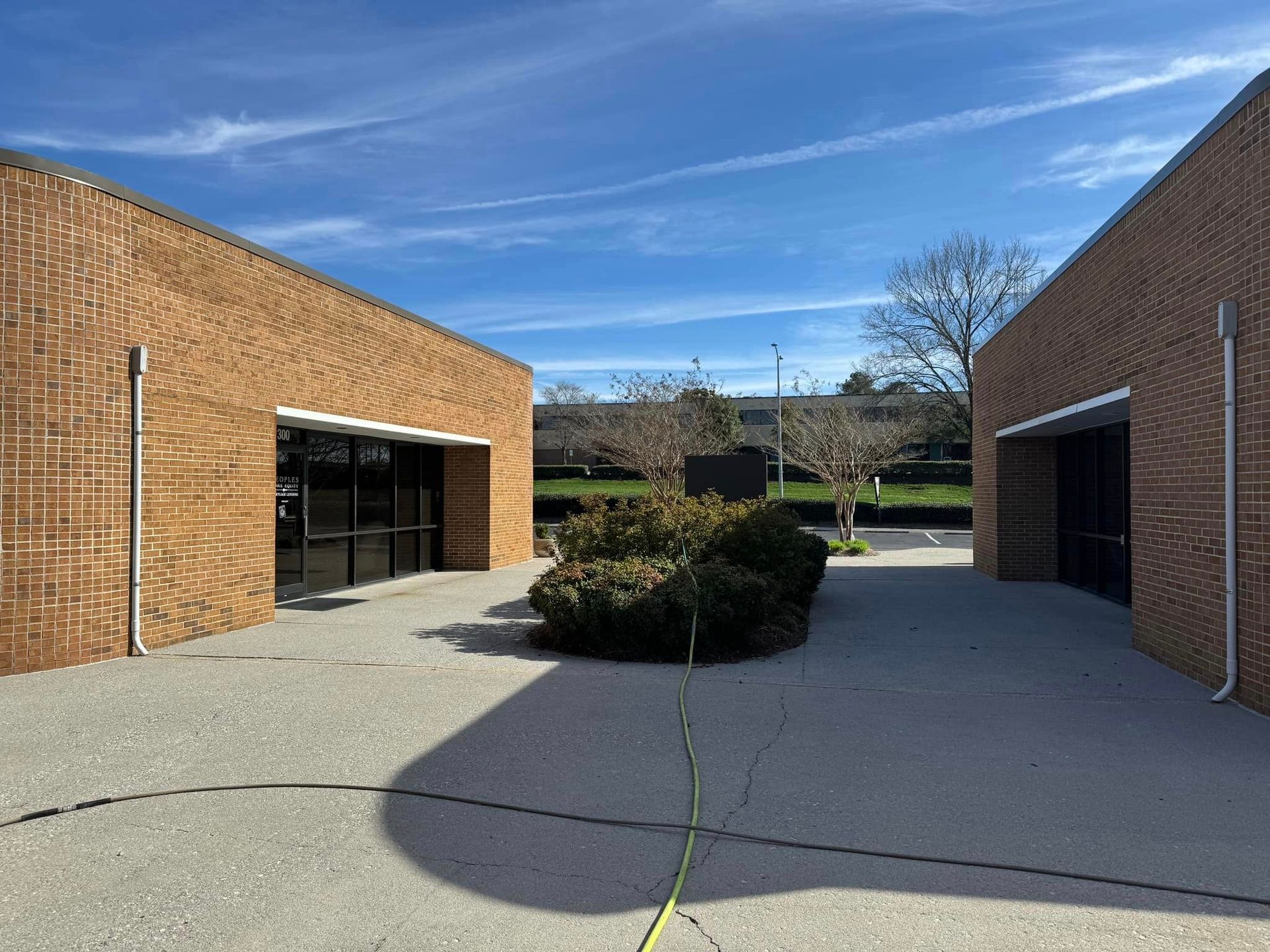 A courtyard between two brick buildings on a sunny day