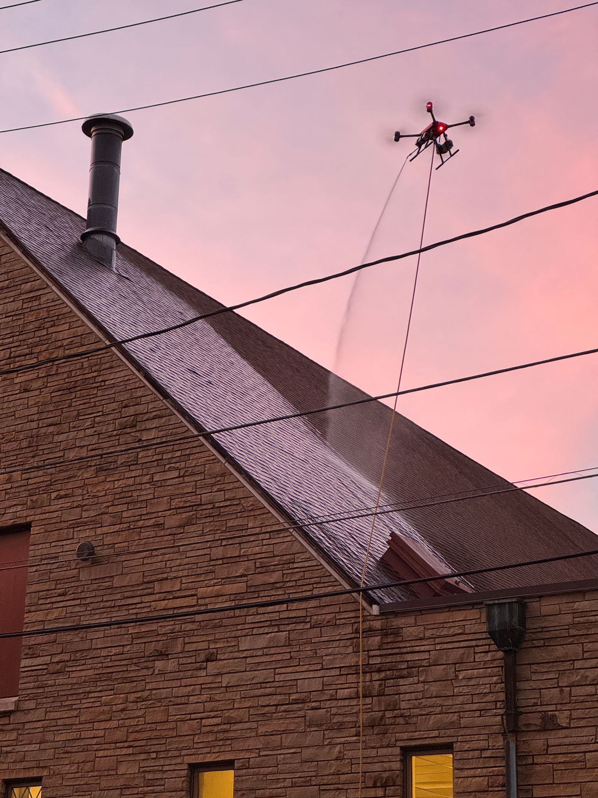 An aerial view of a tennis court with cars parked in front of it. An aerial view of a tennis court with cars parked in front of it.
