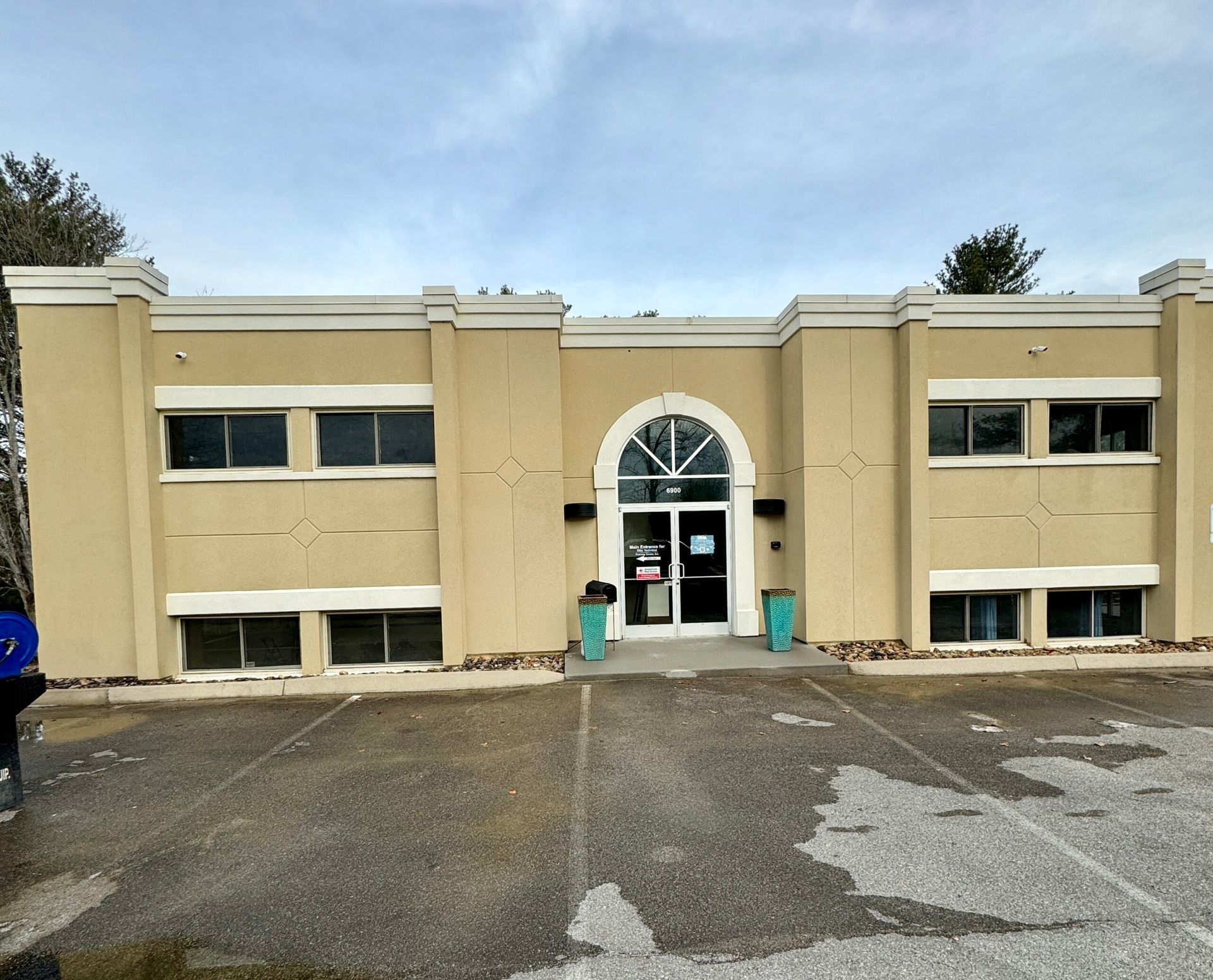 A large building with a car parked in front of it