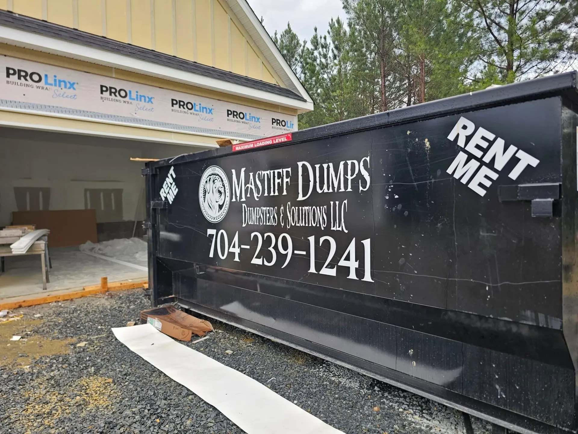 A dumpster that says rent me on it