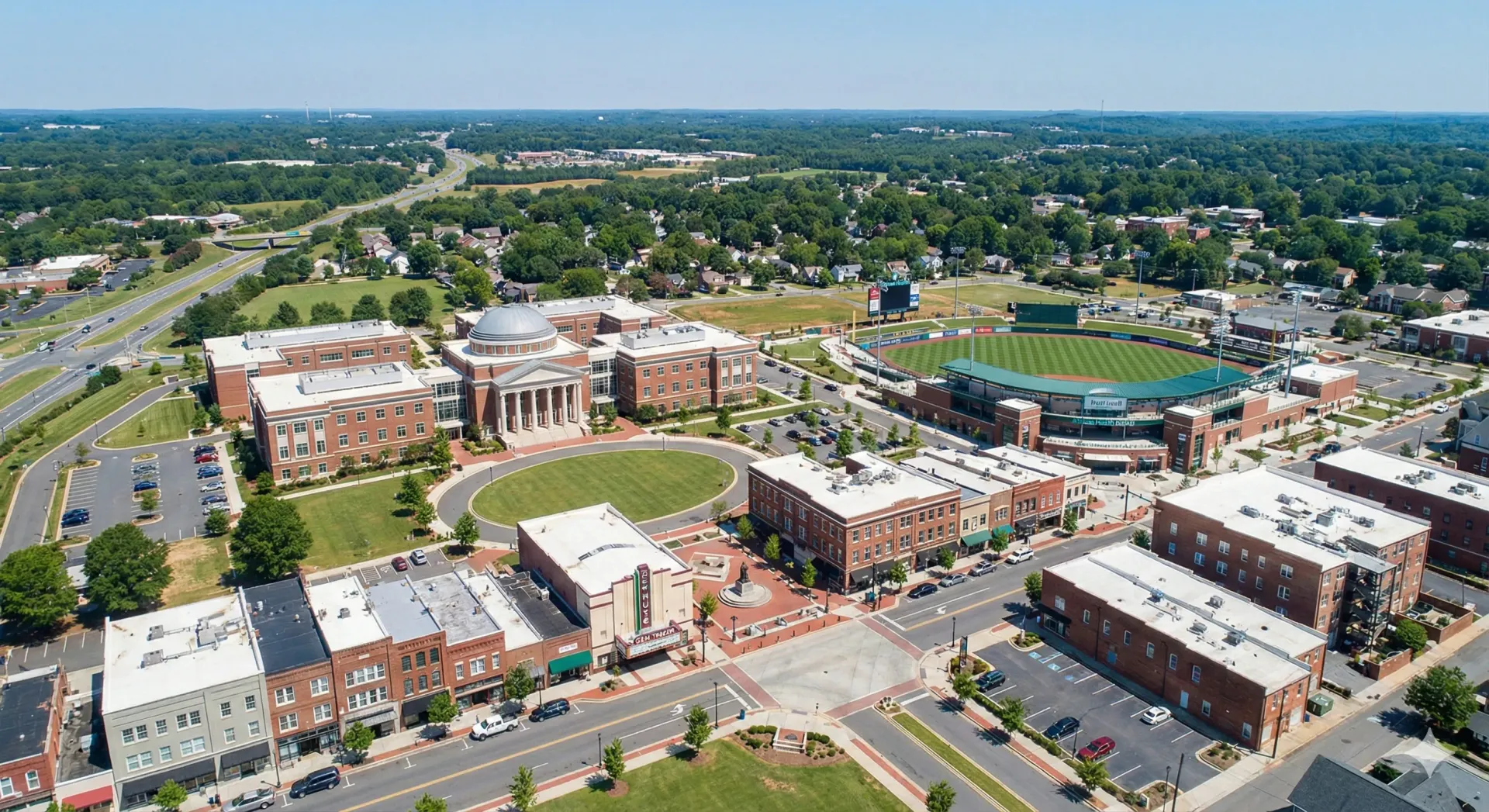 An aerial view of a residential area surrounded by trees and houses.