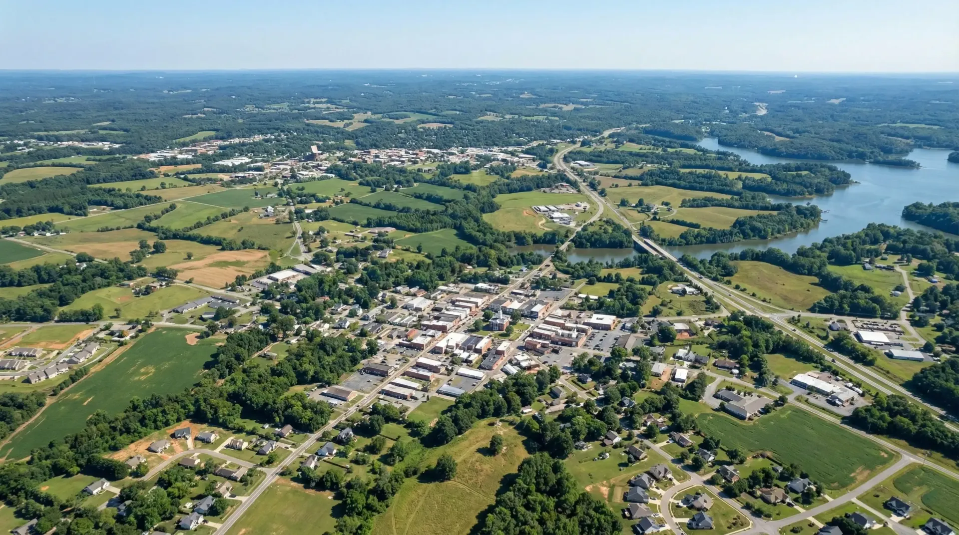 An aerial view of a city surrounded by fields and trees
