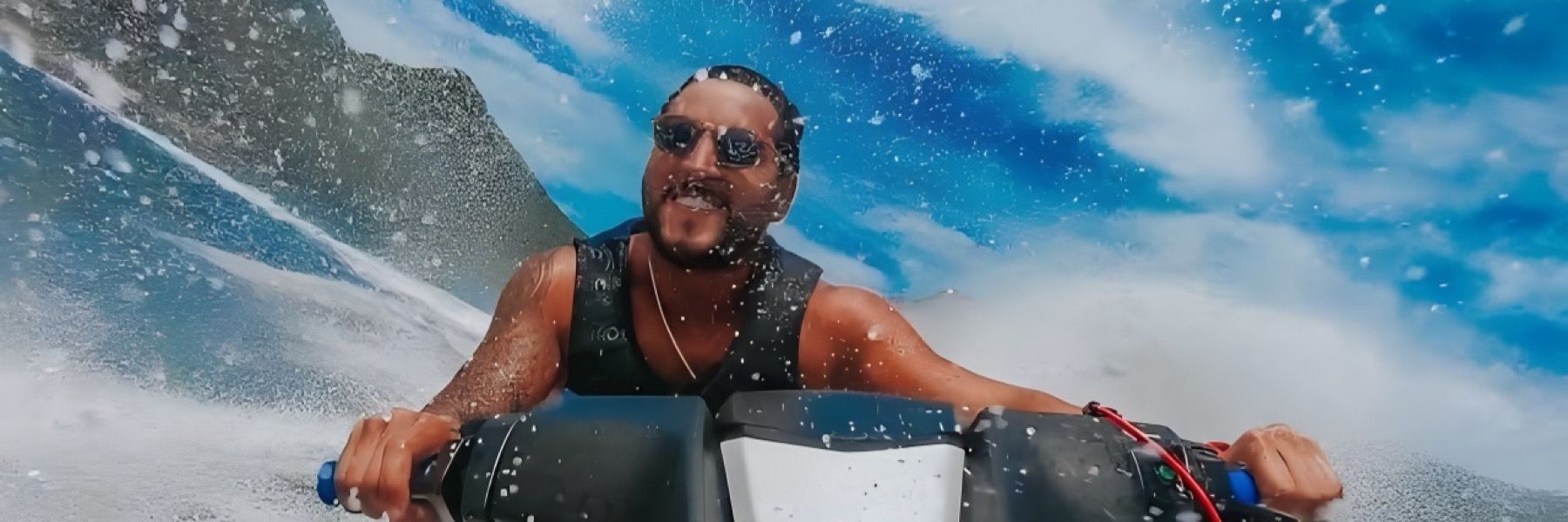 Two people are riding a jet ski in the ocean.