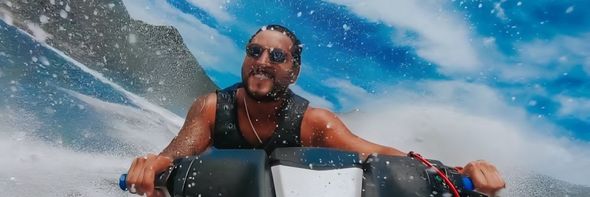Two people are riding a jet ski in the ocean.