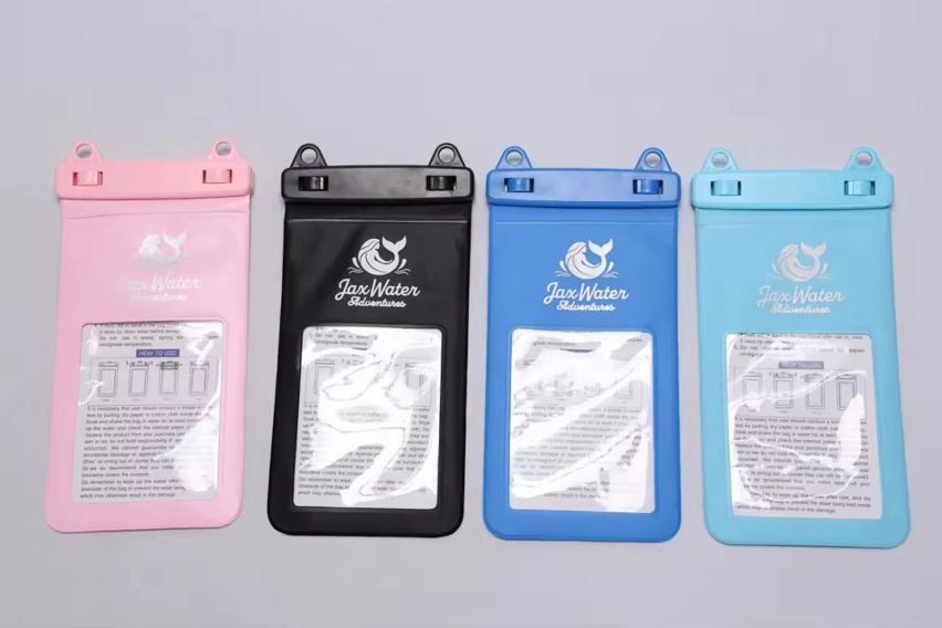 Four waterproof phone pouches: pink, black, blue, and teal. Each has a transparent window, logo, and a latch closure.