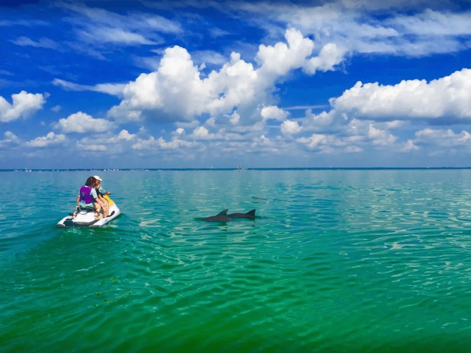 Two people are riding a jet ski on a lake.
