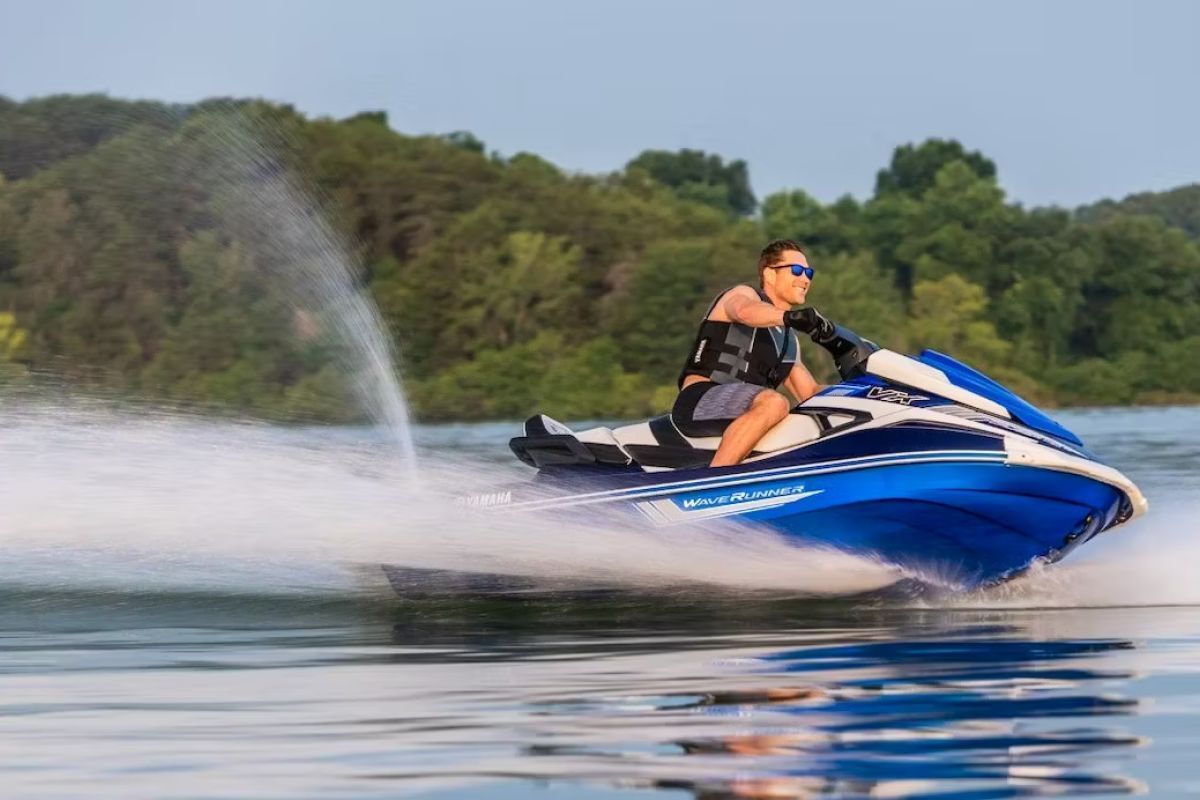 A man is riding a jet ski on a lake.