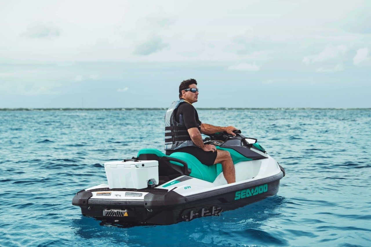 A man is riding a jet ski in the ocean.