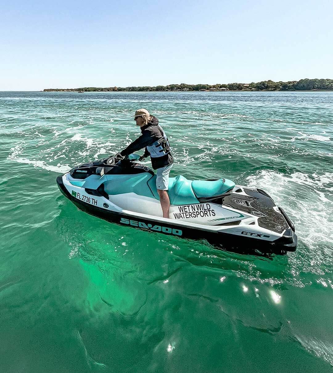 A man is riding a jet ski in the ocean.