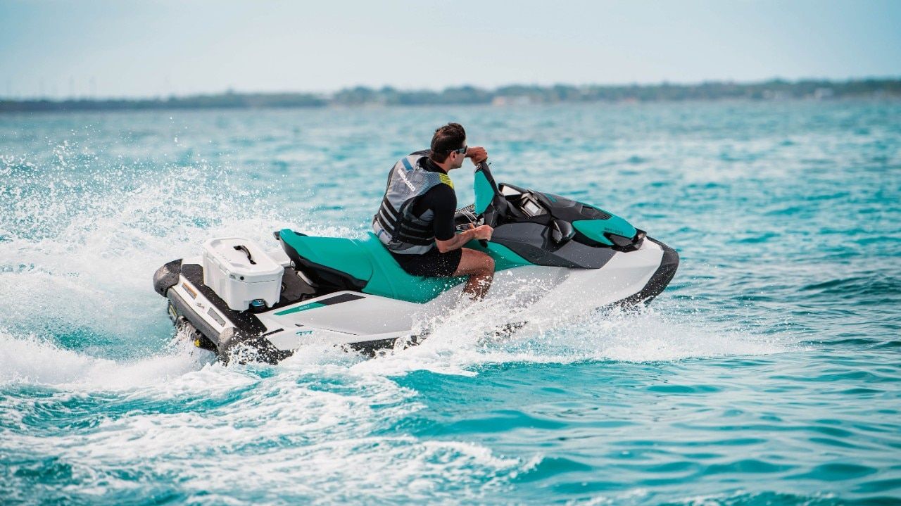 A man is riding a jet ski in the ocean.