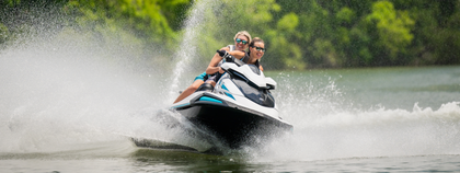 Two people are riding a jet ski on a lake.