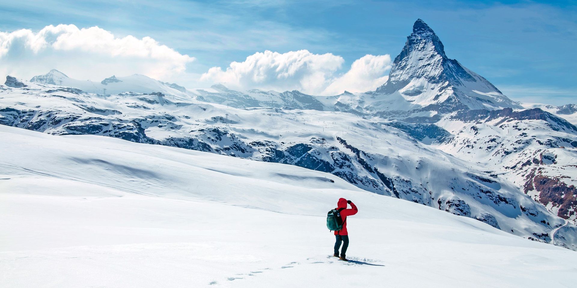 A person exploring the snowy mountains in Switzerland