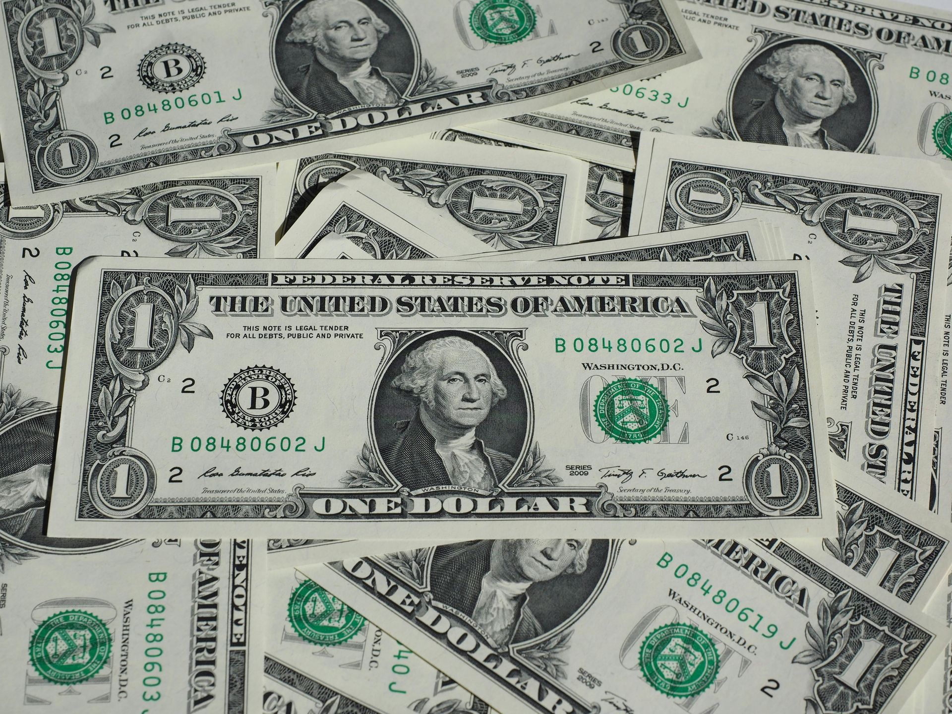 Dollar bills scattered haphazardly to show the foreign currency that UK companies may trade in