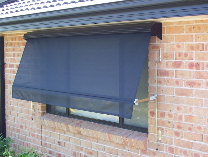 A Brick Building With A Black Awning Over A Window — Mid Coast Flooring & Blinds In Taree, NSW