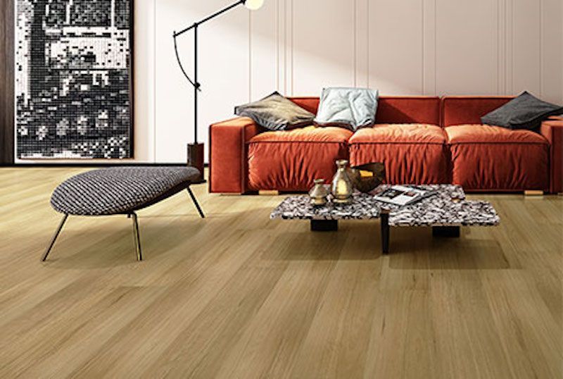 A Living Room With A Red Couch And A Coffee Table — Mid Coast Flooring & Blinds In Taree, NSW