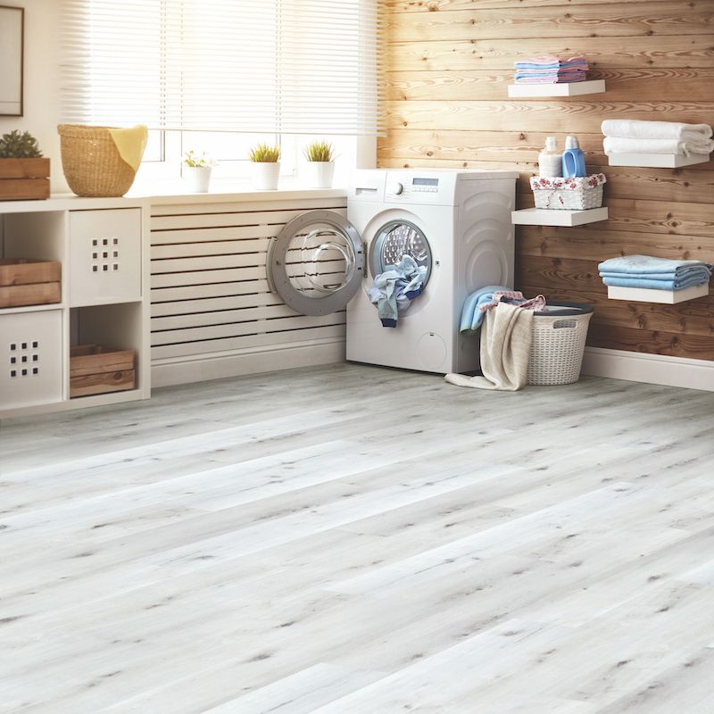 A Laundry Room With A Washing Machine And A Basket Of Clothes — Mid Coast Flooring & Blinds In Taree, NSW