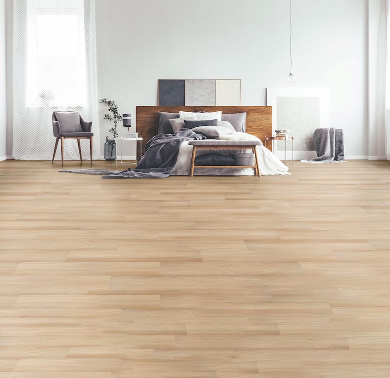 A Bedroom With A Wooden Floor And A Bed — Mid Coast Flooring & Blinds In Forster, NSW