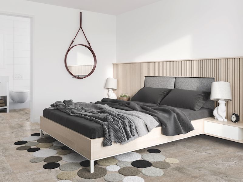 A Bedroom With A Bed And A Mirror On The Wall — Mid Coast Flooring & Blinds In Taree, NSW