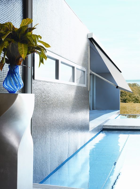 A Blue Vase Sits Next To A Swimming Pool — Mid Coast Flooring & Blinds In Taree, NSW