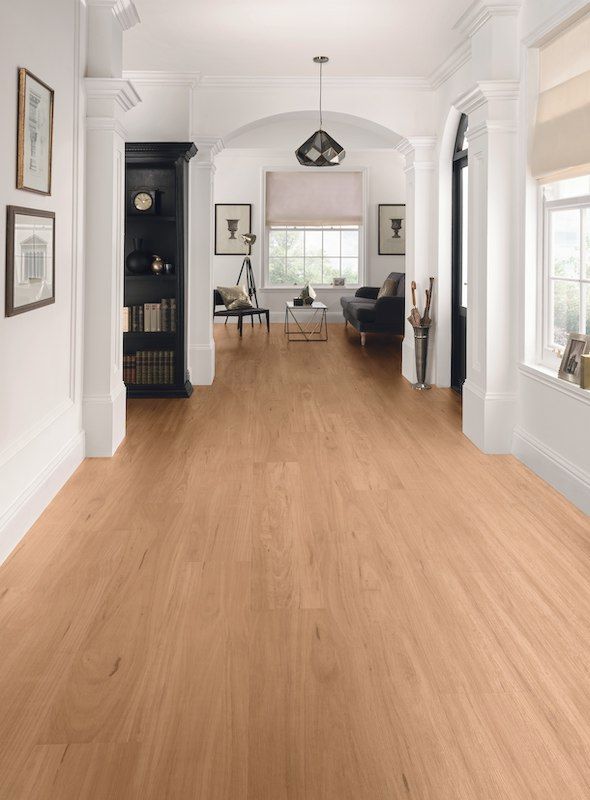 A Living Room With Hardwood Floors And White Walls — Mid Coast Flooring & Blinds In Taree, NSW