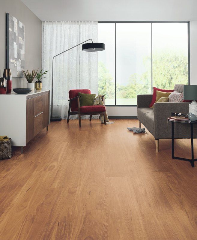 A Living Room With Hardwood Floors And A Couch And Chair — Mid Coast Flooring & Blinds In Taree, NSW